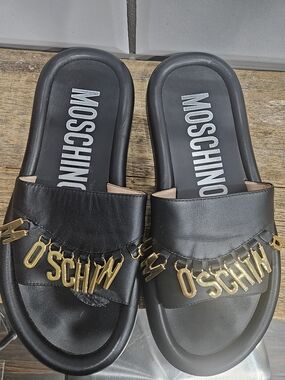 Moschino Black Slides with Gold Lettering Charm